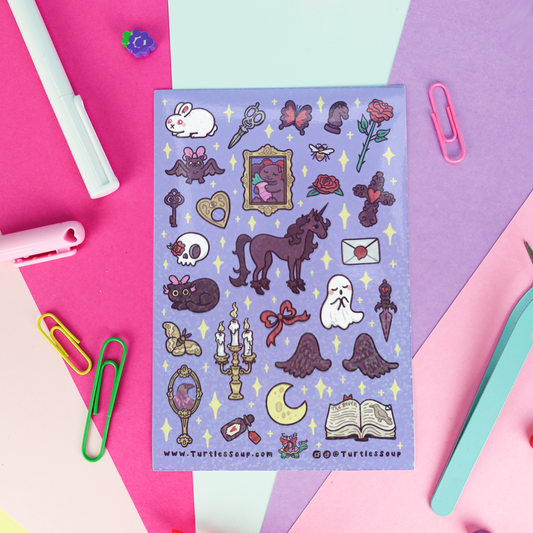 A hand with red manicured nails holds a clear plastic package of 'Turtle's Soup Stickers' against a solid pink background. The sticker sheet features various cute, spooky, and fantasy illustrations like a horse, rabbit, skull, cat, and moon on a lavender background.