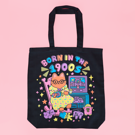 photo of a tote bag with the phrase, "born in the 1900s" featuring a cute old lady cat sitting on her rocking chair surrounded by her favorite millennial nostalgia. 