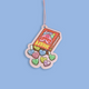 A novelty car air freshener or ornament shaped like a box of Heart Candy, featuring colorful heart-shaped candies spilling out, suspended by a thin pink string against a solid light blue background.