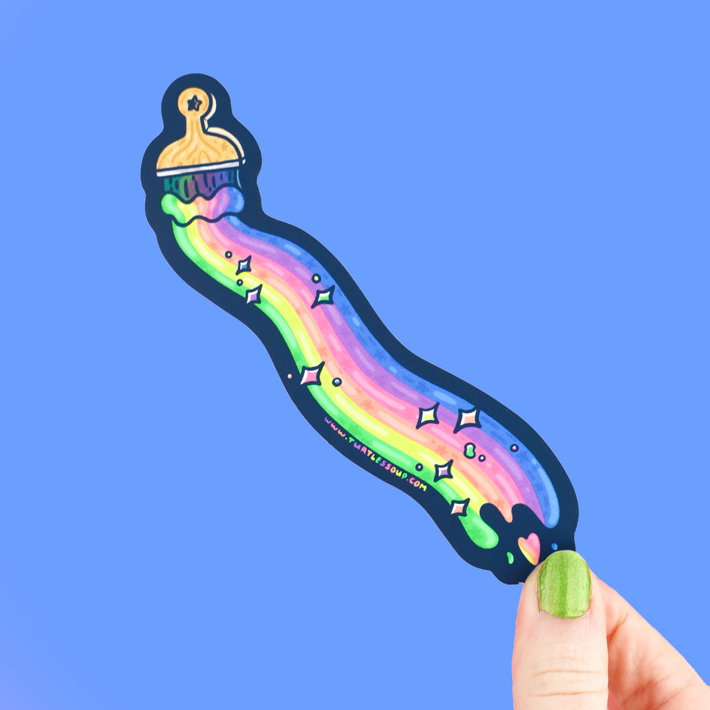 Long bookmark shaped like a paintbrush with a streak of rainbow paint