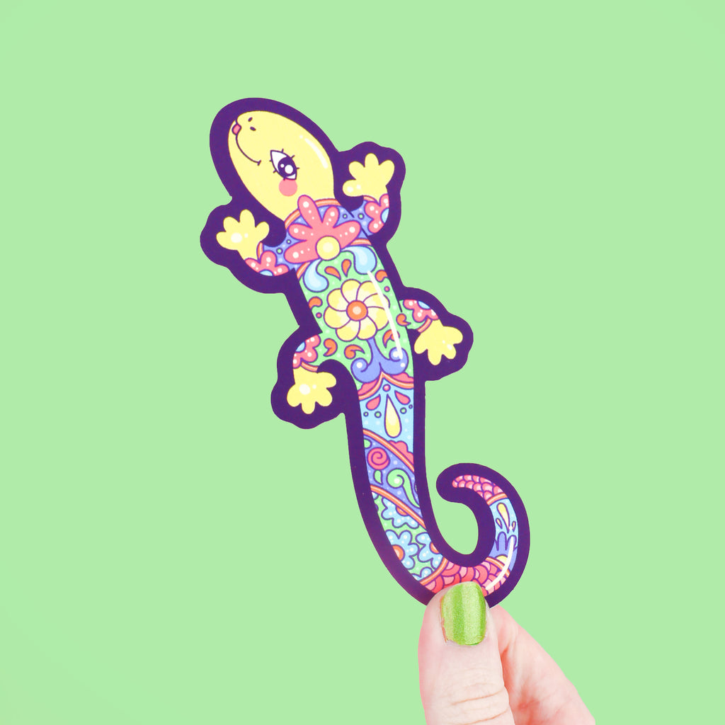 Bookmark shaped like a long lizard who has a colorful pattern of flowers and art on its back, resembling mexican pottery