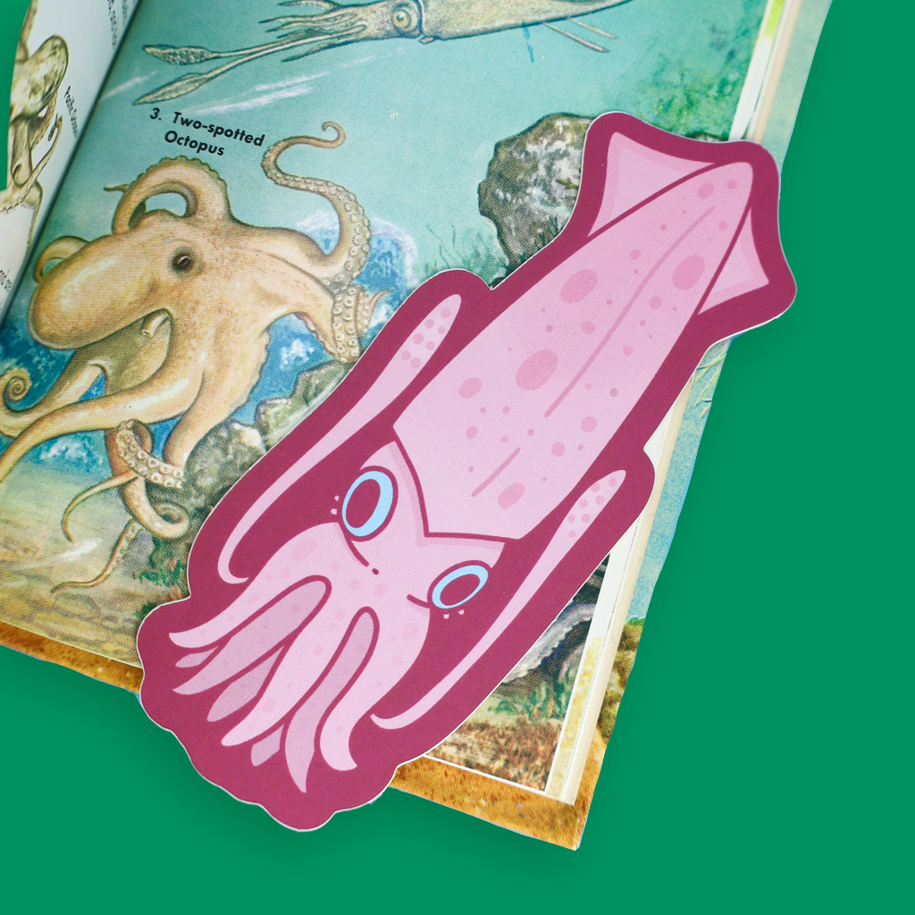 A pink cartoon squid bookmark or sticker with blue eyes, placed on top of an illustrated octopus book page against a solid green background.