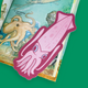 A pink cartoon squid bookmark or sticker with blue eyes, placed on top of an illustrated octopus book page against a solid green background.