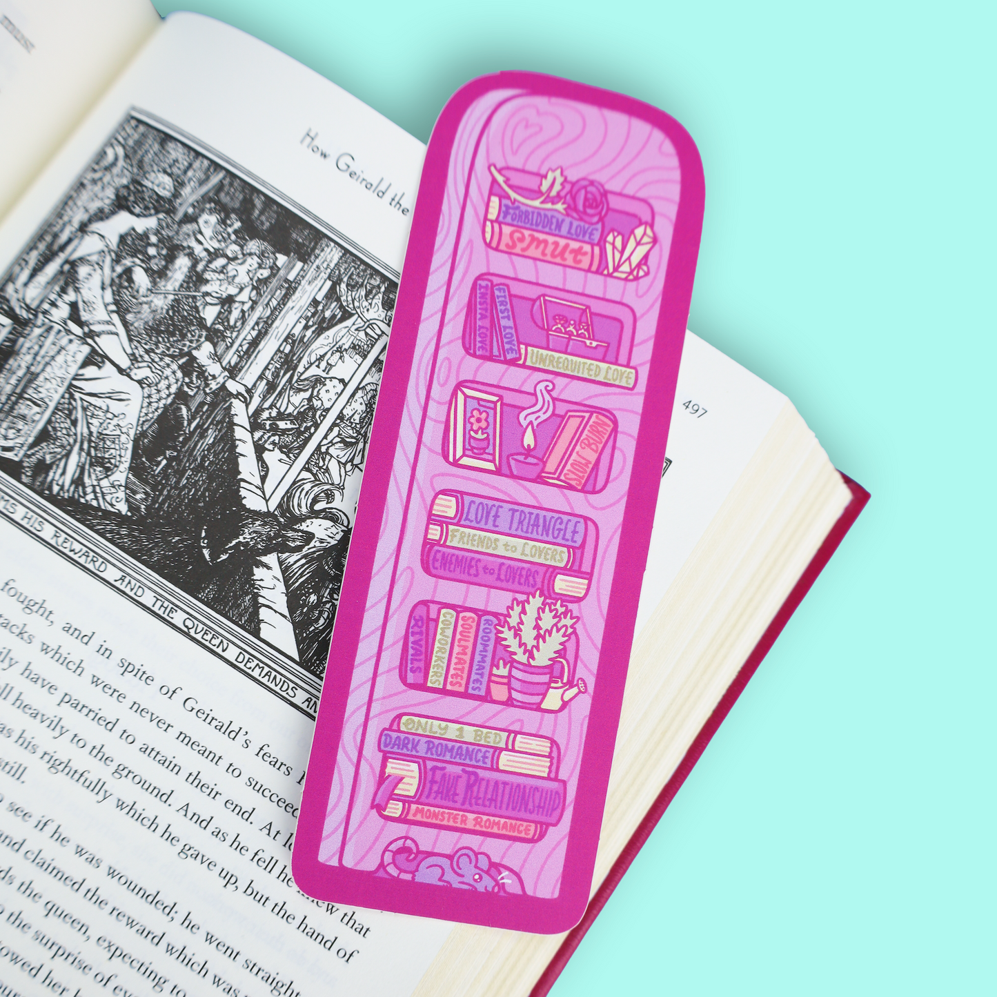 A pink rectangular book bookmark with illustrated book spines and book-themed text, placed on an open book against a mint blue background.