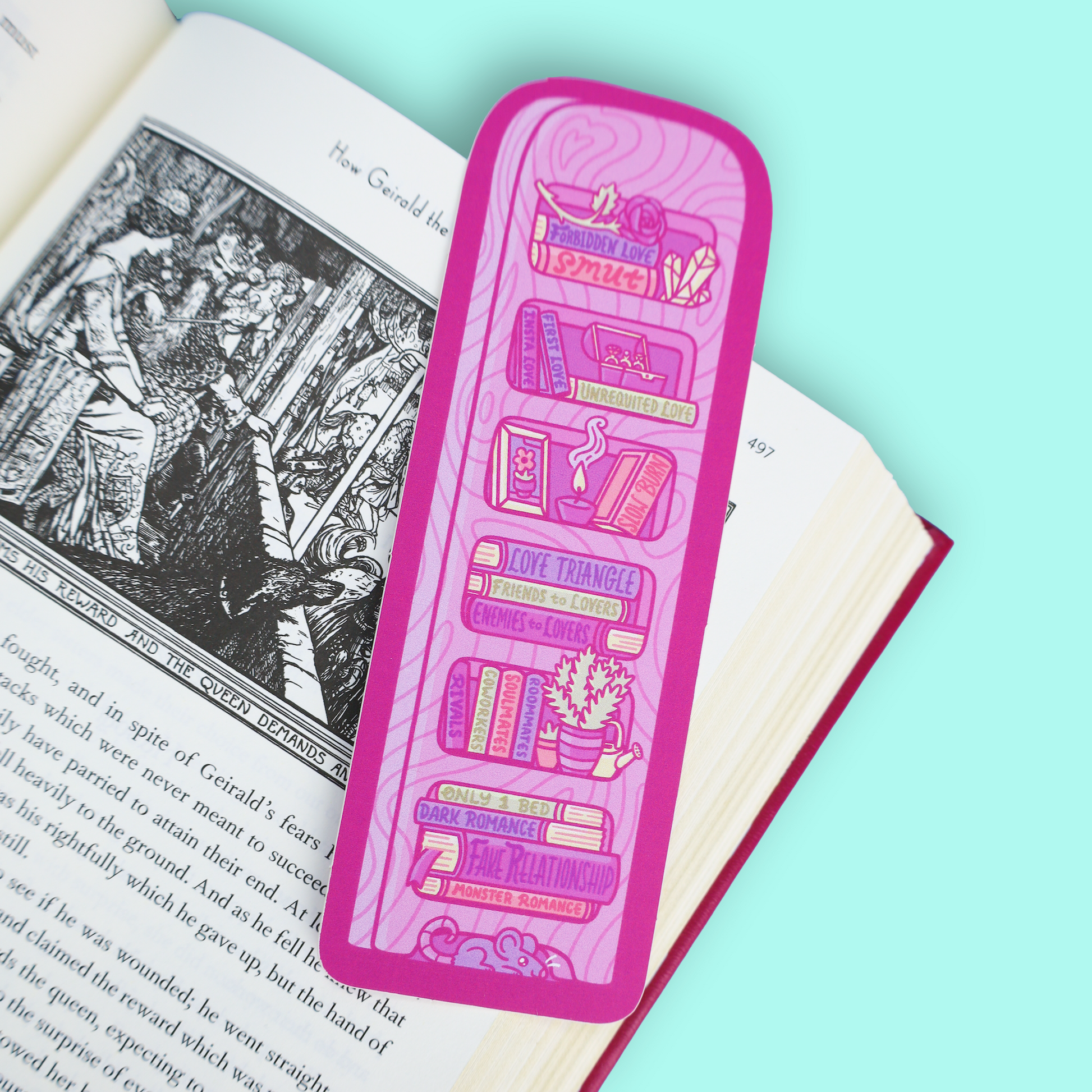 A pink rectangular book bookmark with illustrated book spines and book-themed text, placed on an open book against a mint blue background.