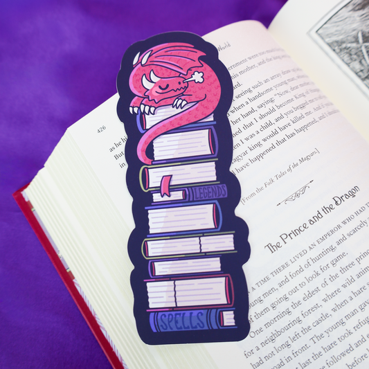 bookmark of a dragon sleeping on a stack of books