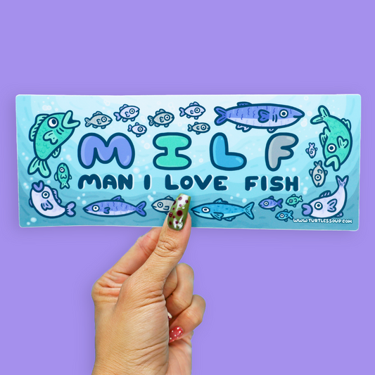A hand holds a rectangular sticker against a solid purple background. The sticker features a light blue watercolor-style background with cartoon fish and the text 'MILF MAN I LOVE FISH' in blue and teal lettering.