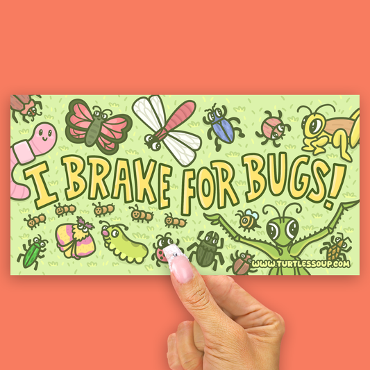A rectangular printed card or sticker with a light green background and colorful cartoon bugs, held by a hand against a coral-orange backdrop. The card reads “I BRAKE FOR BUGS!” with “www.