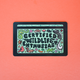 A rectangular black sticker with a colorful illustrated design reading 'CERTIFIED WILDLIFE ENTHUSIAS' on a coral background.