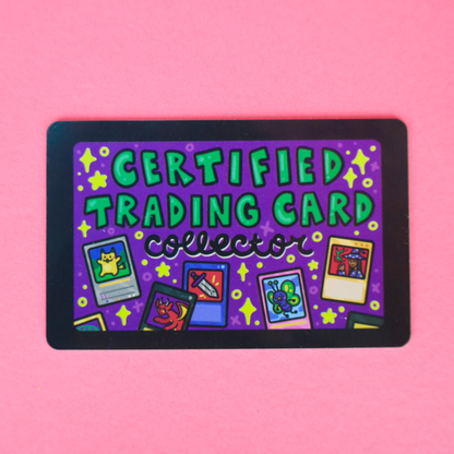 A rectangular collectible trading card with a black border and a purple background, featuring the text 'CERTIFIED TRADING CARD collector' in green and multicolor retro card illustrations, displayed on a solid pink background.
