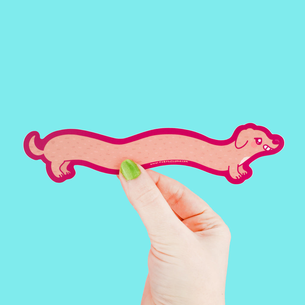 Long sticker shaped like a weenie dog with a happy smile