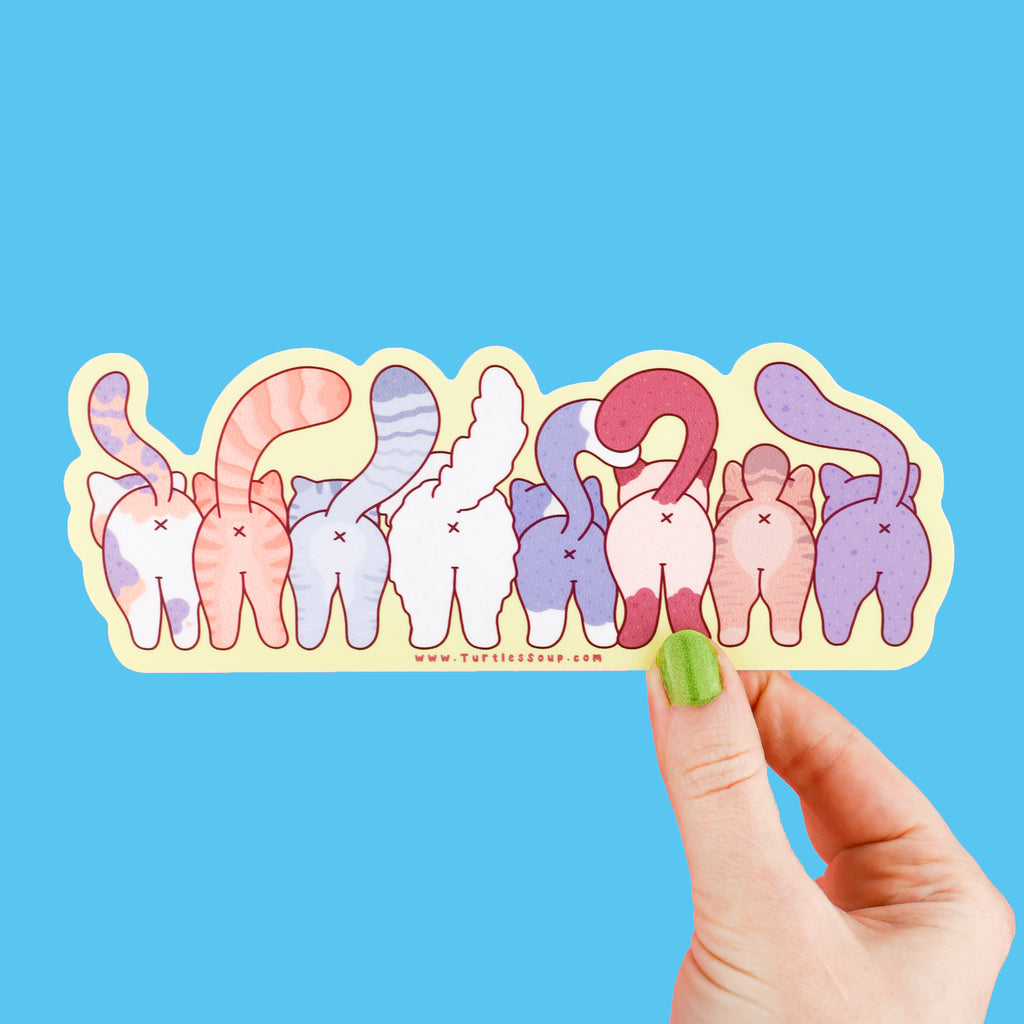 A long sticker featuring a group of cats standing together in a row, they are facing backwards to show off their cute butts
