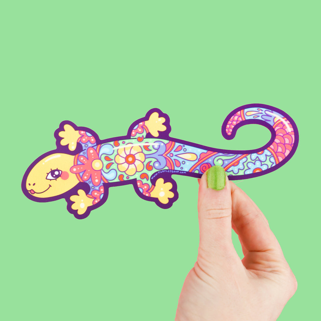 Sticker shaped like a long lizard who has a colorful pattern of flowers and art on its back, resembling mexican pottery