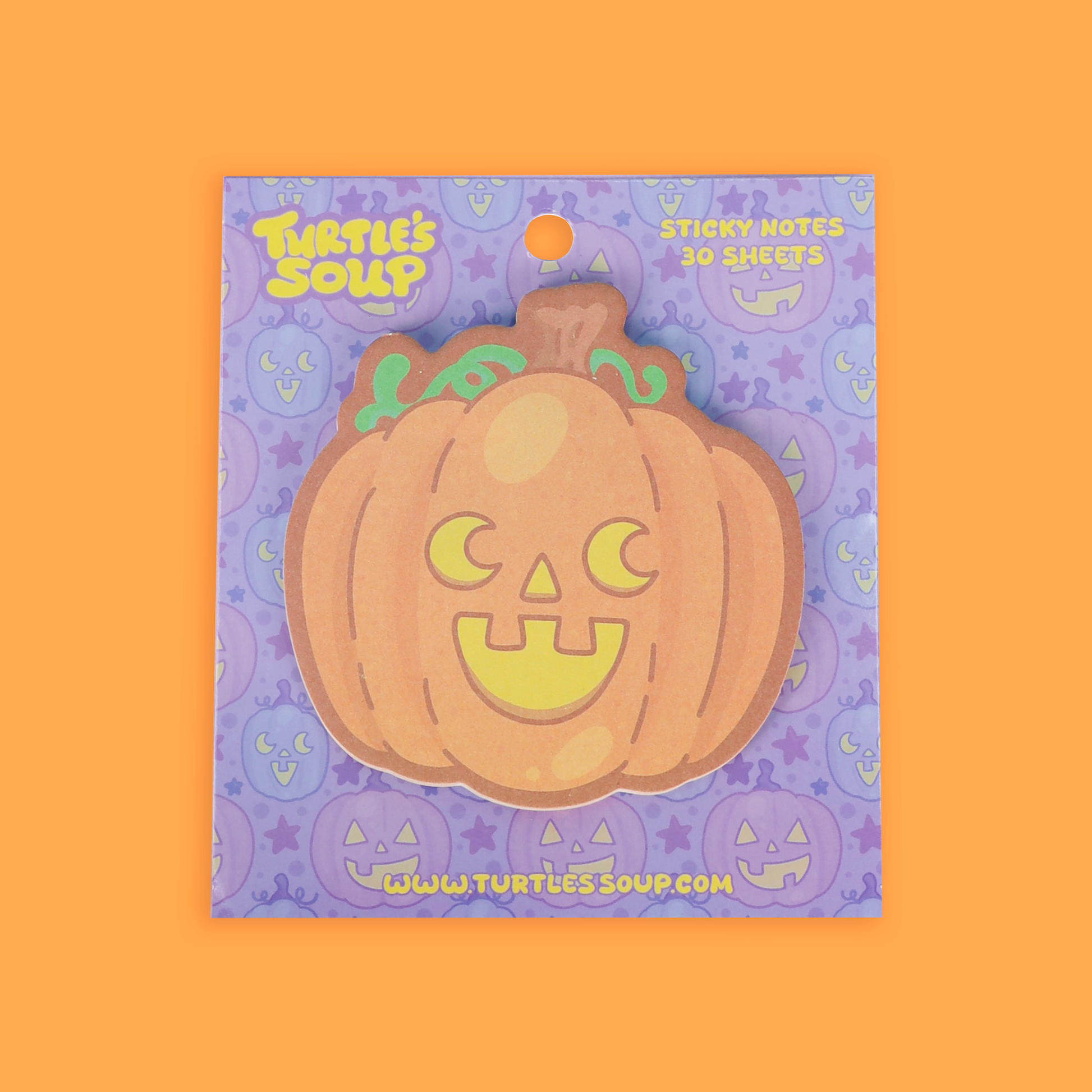 cute jack-o-lantern pumpkin sticky note pad on an orange back drop