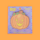 cute jack-o-lantern pumpkin sticky note pad on an orange back drop