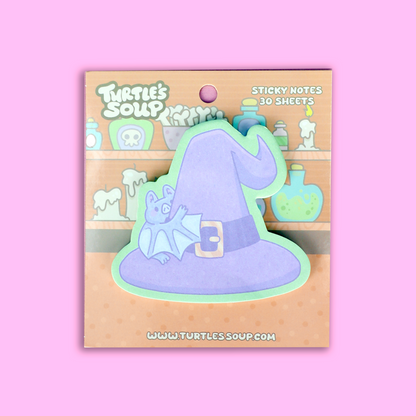 A package of Turtle's Soup brand sticky notes on a solid pink background. The product features a cute illustration of a small blue bat perched on a purple witch hat with a mint green border.