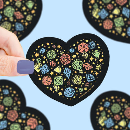 Heart-shaped sticker with colorful geometric design held by a hand against a blue background