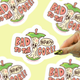 Sticker with 'Bad to the Core' design on a yellow background