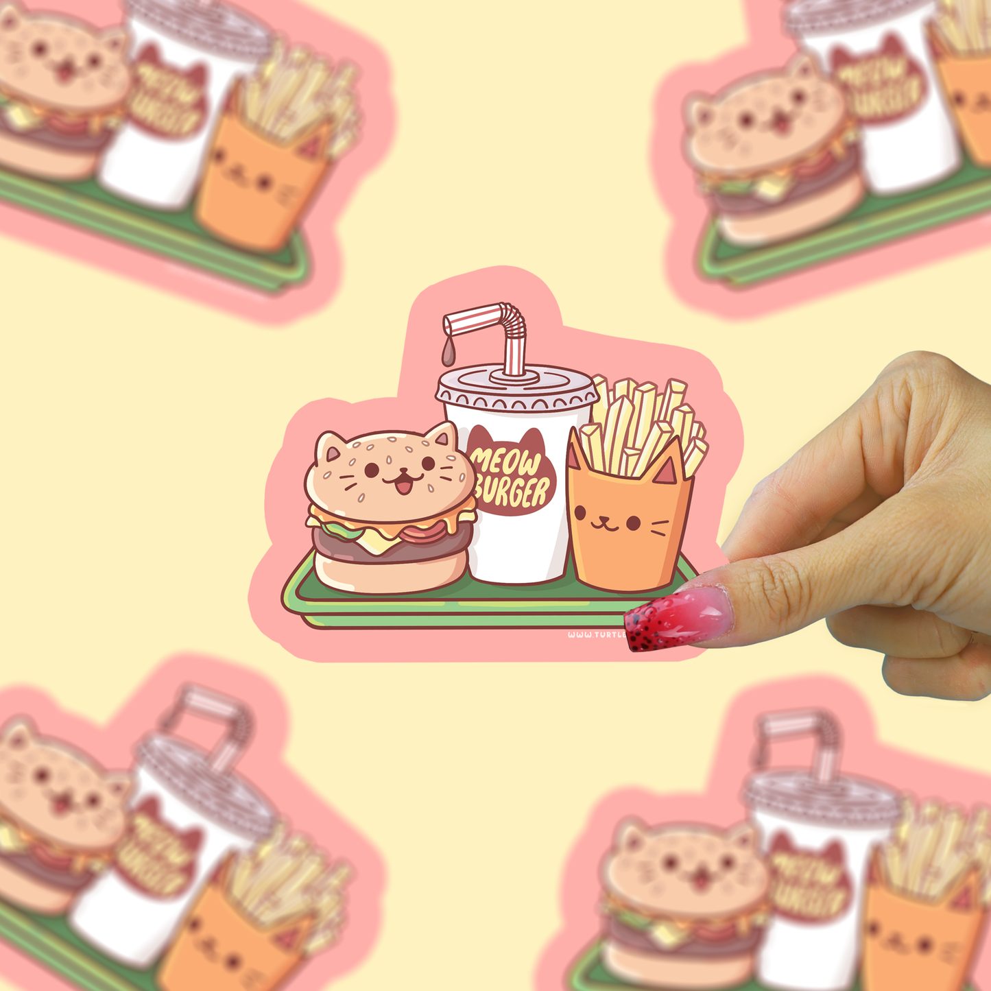 Cute sticker of a cat burger, fries, and drink with a hand holding it against a similar background.