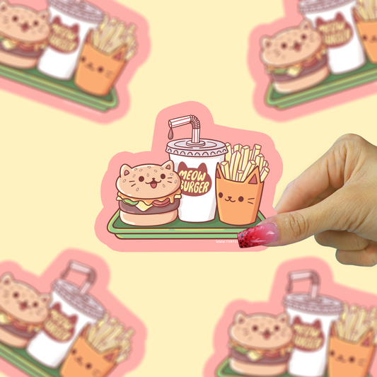 Cute sticker of a cat burger, fries, and drink with a hand holding it against a similar background.
