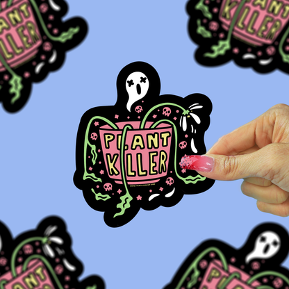a vinyl sticker of a dead plant with a ghost coming out of the pot being held up against a blue background.