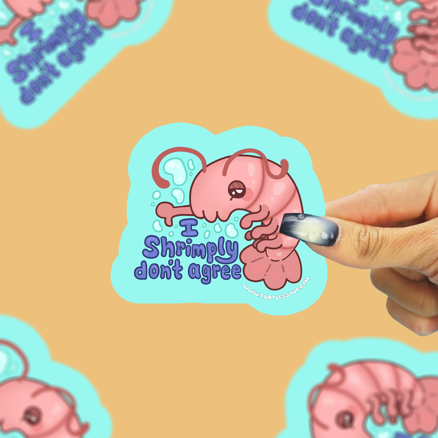 A hand is applying clear nail polish to a die-cut sticker featuring a pink shrimp character with the text 'I Shrimply don't agree'. The background is a warm tan color with other copies of the sticker pattern visible.