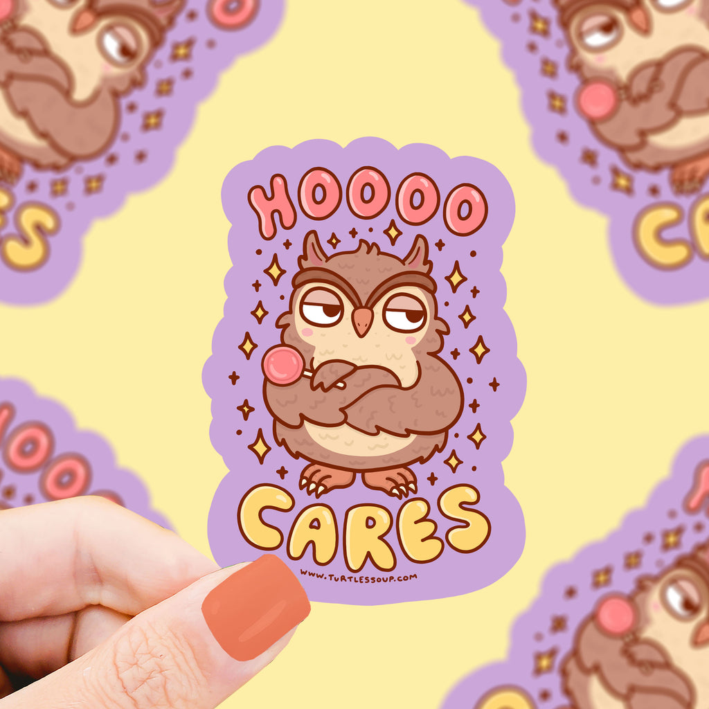 A grumpy owl holding a lollipop and crossing his arms. Text says "hoooo cares"