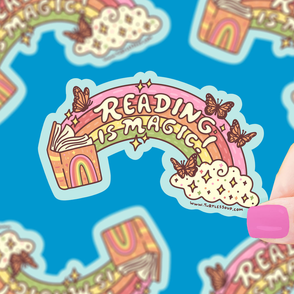 A colorful open book with a rainbow coming from it, with sparkles and butterflies. Text says "reading is magic"