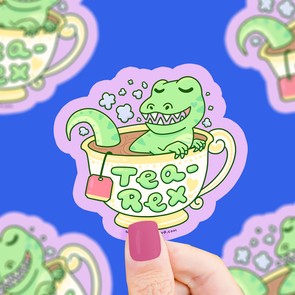 A tea cup with a t-rex resting inside, the text says "tea-rex"