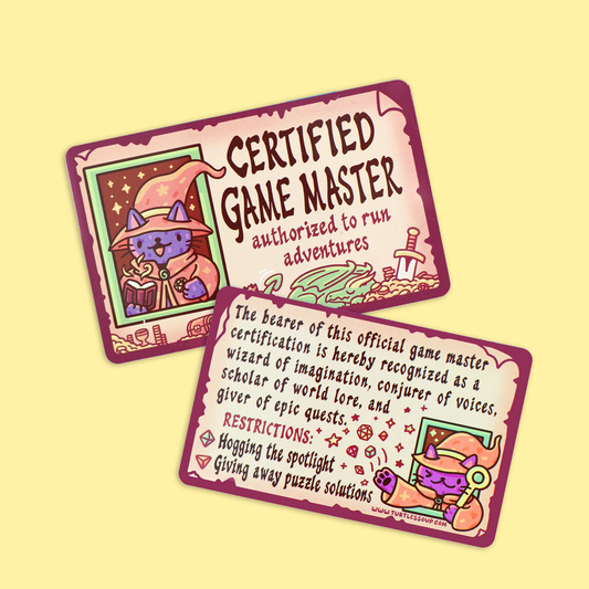 Two illustrated game master cards with purple borders and whimsical fantasy artwork, shown on a pale yellow background. One card reads 'CERTIFIED GAME MASTER' and the other contains rules text about hugging spotlight and giving away puzzle solutions.